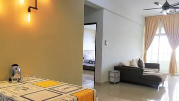 Deluxe Apartment, Multiple Beds, City View | Living area | 50-inch LED TV with digital channels, TV, video-game console