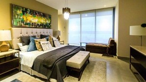 A modern bedroom with a large bed, a view of the city through large windows, and a cityscape painting on the wall.