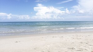 A beach with a clear sky and calm sea. - : Sandy Feet Retreat: Walk to the Beach! : (Jupiter)
