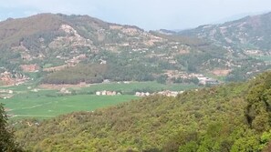 A mountainous landscape with scattered buildings, likely a rural or semi-rural area. - Lala Palace Resort (Panaoti)