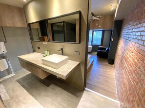 A modern bathroom with a large mirror, a rectangular sink, and a wooden vanity. - PInHouse (Kaohsiung)