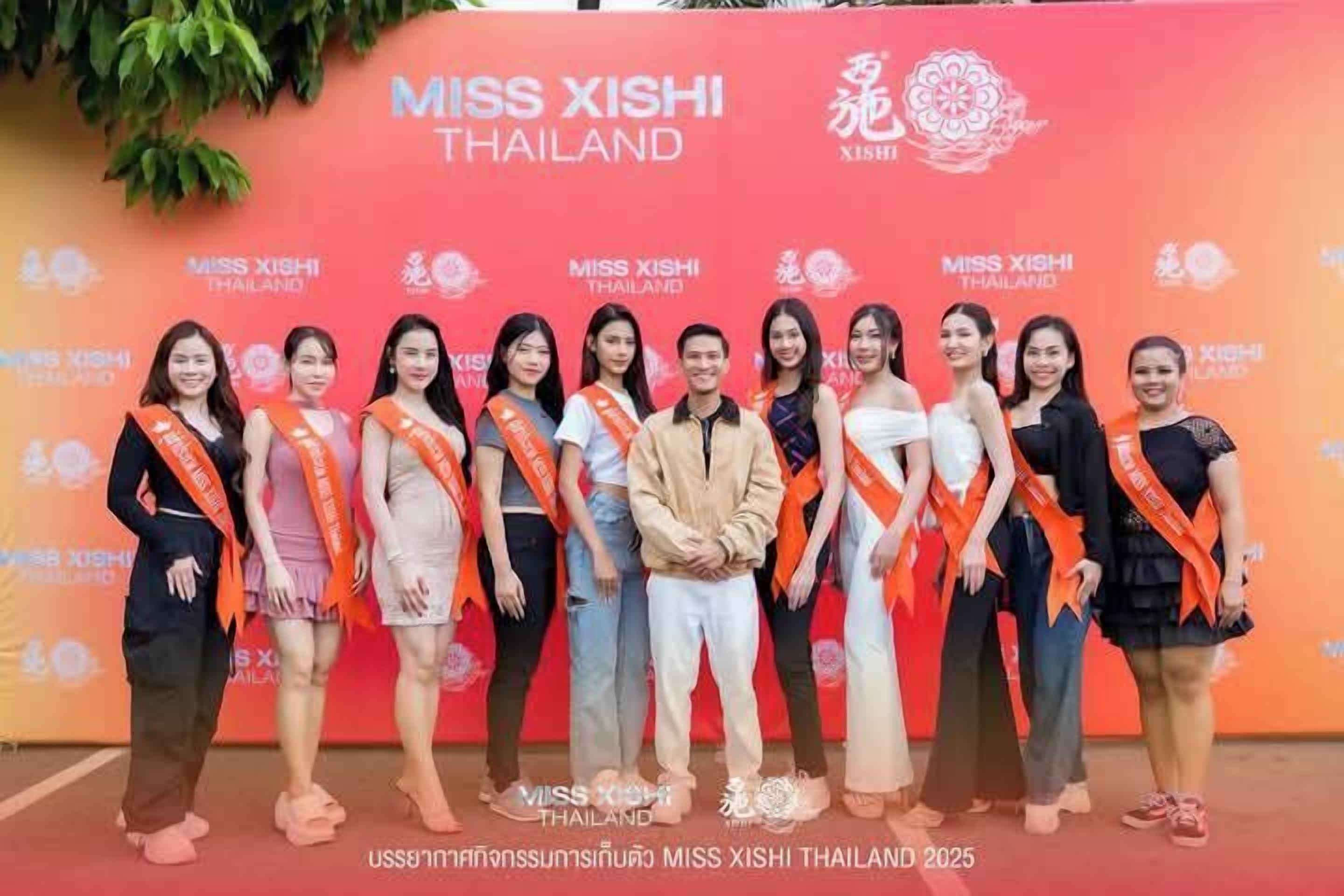 A group of people standing in front of a backdrop with the text "MISS XISHI THAILAND".