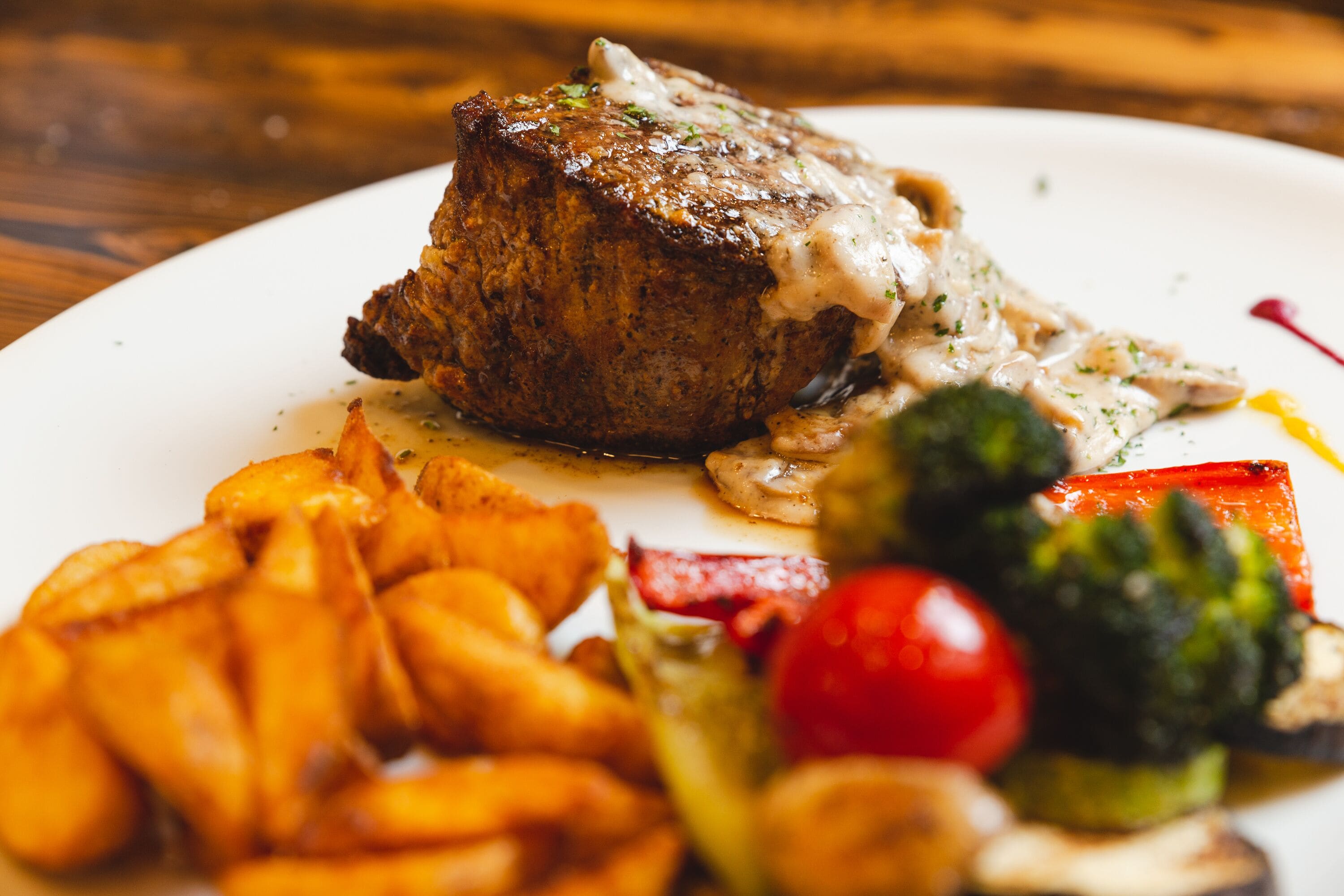 A plate with a steak, fries, and vegetables.