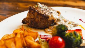 A plate with a steak, fries, and vegetables.