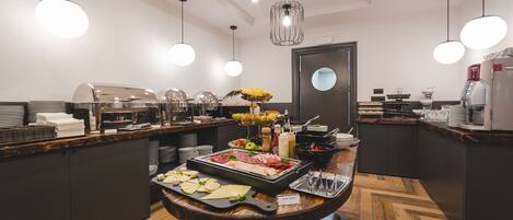 A buffet setup with various food items and a central serving area.