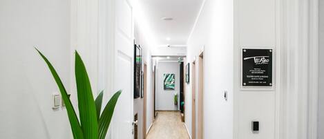 A clean, well-lit hallway with a sign indicating a theater suite and rooms.