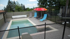 A swimming pool with a covered area, lounge chairs, and umbrellas. - Cottage in Saint-Haon-le-Châtel with pool and pets allowed (Saint-Haon-le-Châtel)
