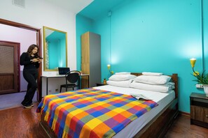 A bedroom with a bed, a desk, a chair, and a mirror. - Freelander Work and Travel Hostel (Bishkek)