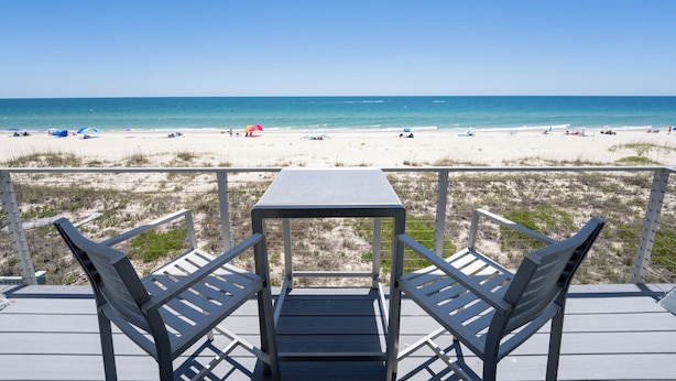 A deck with a table and chairs overlooking a beach. - August 2026 Big Savings!!! Remodeled bathrooms! BEACHFRONT (St. George Island)