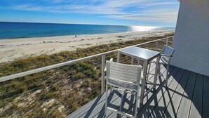 A balcony with a view of a beach and ocean. - August 2026 Big Savings!!! Remodeled bathrooms! BEACHFRONT (St. George Island)