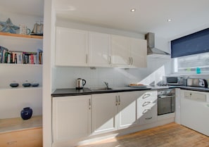 Enjoy cooking in this well-equipped kitchen with a dishwasher, microwave, oven, and sink.