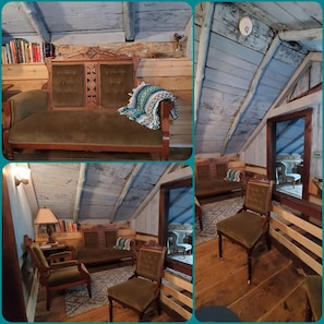 Cozy attic room with a comfortable sofa, wooden chair, and reading nook.