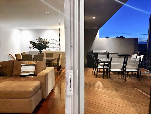 Relax in this spacious living and dining area, featuring a sofa set, coffee table, dining table, and chairs.