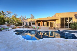 A modern house with a swimming pool, outdoor furniture, and a patio area. - Luxury Resort Style Home -Spectacular Red Rock Views, Pool, Hot Tub, Firepit (Sedona)