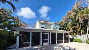 A two-story building with a covered porch and a sign indicating it is a gallery house.