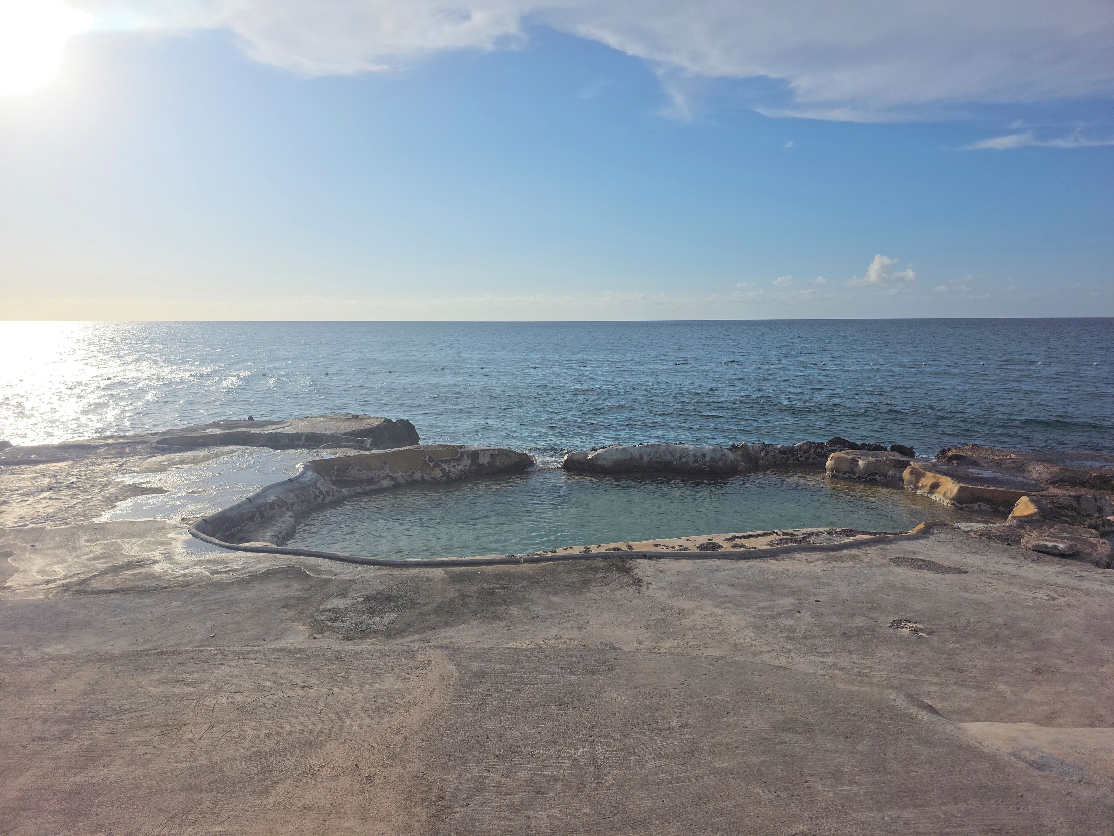 A coastal landscape with a clear sky and calm sea.
