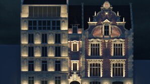 A multi-story building with a mix of modern and traditional architectural styles, featuring large windows and decorative elements. - Hotel Le Ballu (Paris)