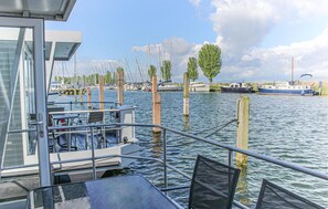 A marina with boats docked, wooden pilings, and a clear sky. - Cozy ship in Lelystad (Lelystad)