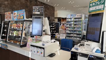 A self-checkout area with a digital screen, a menu board, and a shoe display.