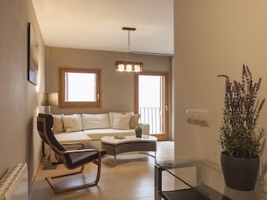 Relax in this stylish living room with a sofa set, coffee table, and comfortable chair.