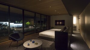 A modern bedroom with a large window, a bed, a small table with cups, and a chair. - Hotel Canata Kyoto (Kyoto)