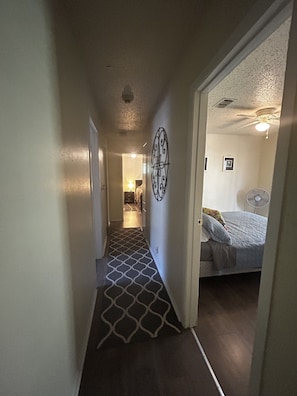 Enter a cozy bedroom with a comfortable bed and ceiling fan.