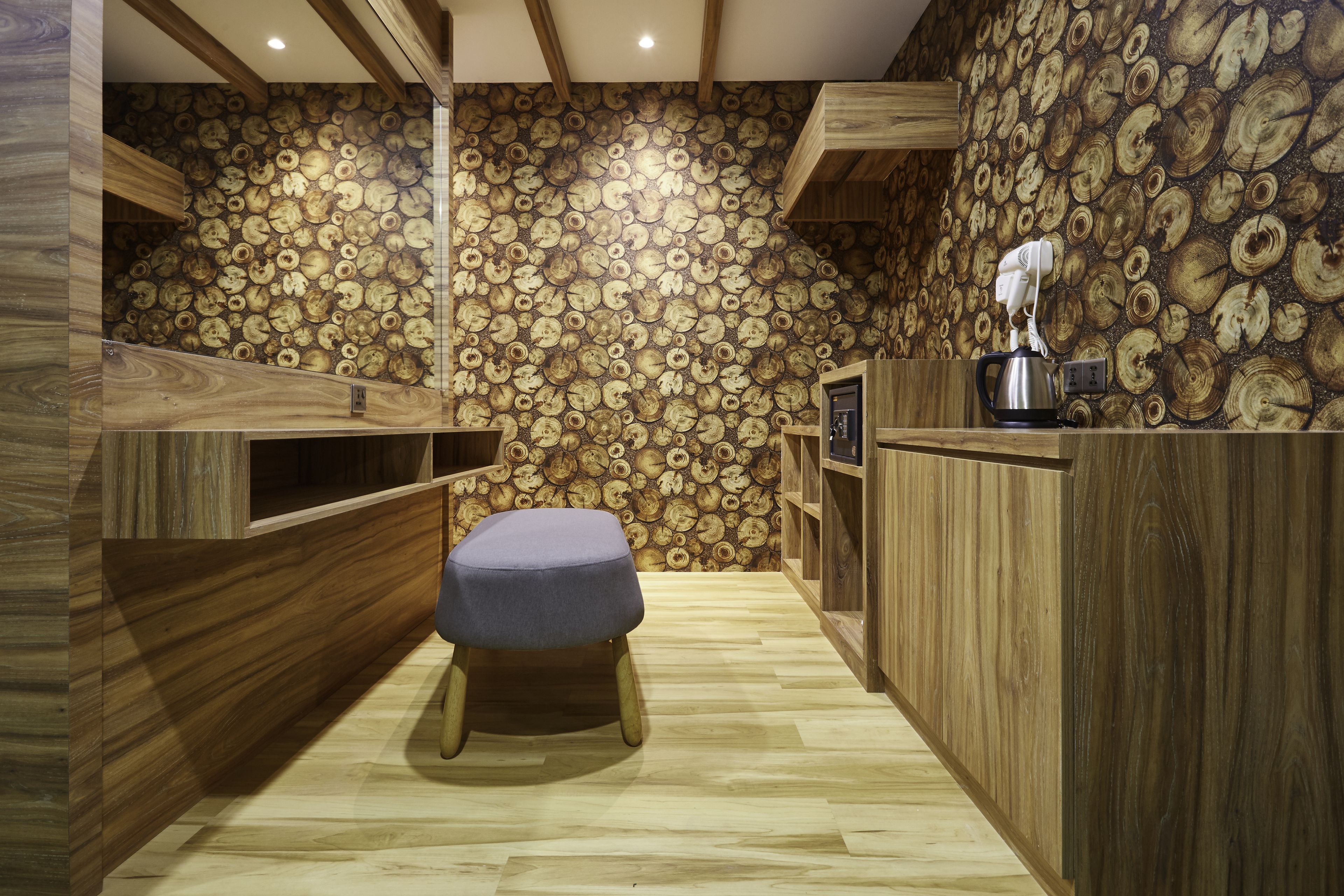 A wooden interior with a central bench, wooden walls, and a ceiling with exposed beams.