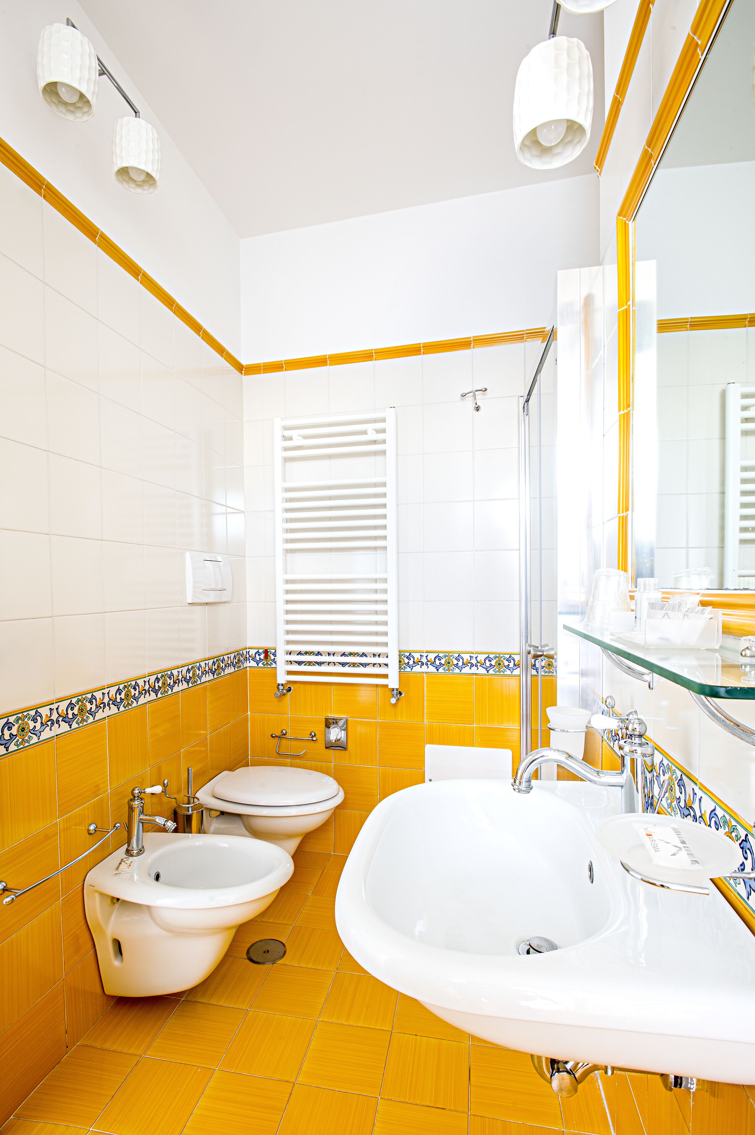 A bathroom with two sinks, a toilet, and a shower.
