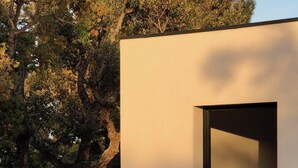A modern outdoor deck with wooden loungers and a view of a bedroom through an open doorway. - South Corsica, Villa 14 p, swimming pool, beach at 300m (Sainte-Lucie de Porto-Vecchio)