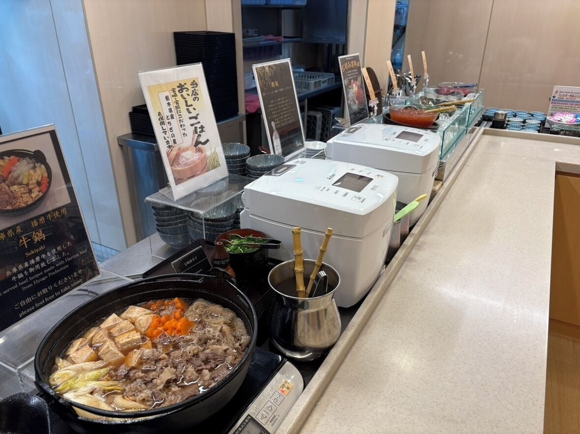 A buffet area with various dishes, including a large pot of stew and several bowls of food.