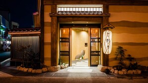 A traditional building entrance with a wooden door, a tiled roof, and a stone pathway leading to the entrance. - Onyado Nono Asakusa Natural Hot Springs (Tokyo)
