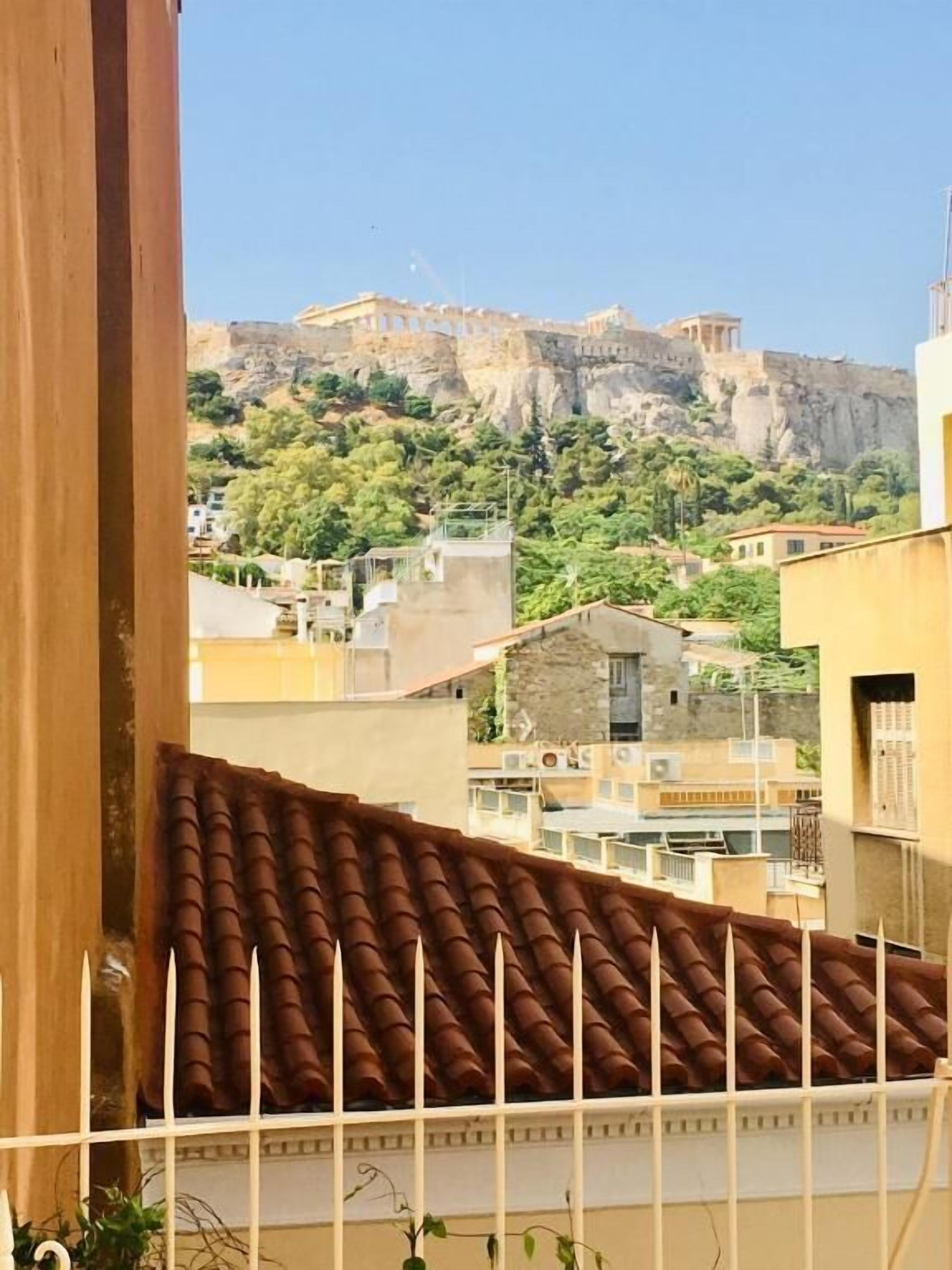 A view of a building with a tiled roof and a balcony.