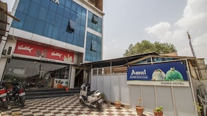 A hotel with a checkered floor, a sign for 'Rudra Hotel', and a parked scooter. - Hotel Rudra (Majhgawan)