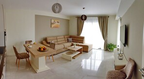 Apartment, Sea View | Living area | Flat-screen TV, DVD player