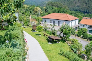 A residential area with a paved path, a bench, and a small park with a fountain.