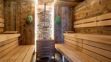 A sauna with wooden benches and a central bench with a sink.