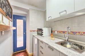 Apartment | Private kitchen | Fridge, microwave, stovetop, cookware/dishes/utensils