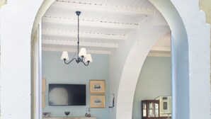 A bedroom with a bed, a television, and a fireplace. - Charming Cretan House, Jasmine (Σητεία)