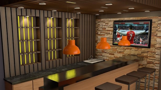 A modern kitchen with a large island, bar stools, pendant lighting, and a TV mounted on a stone wall. - Snow Peak Hotel (Chogoria)
