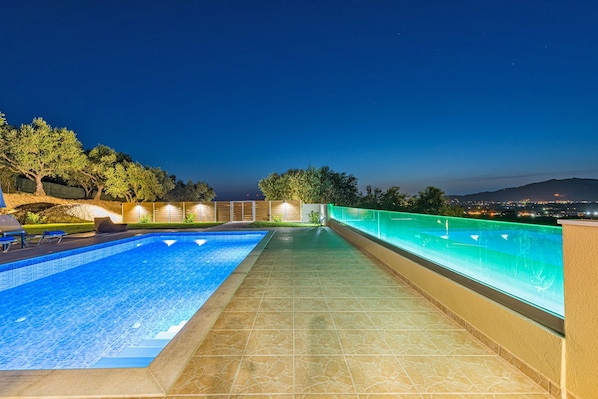 Seasonal outdoor pool, pool umbrellas, pool loungers