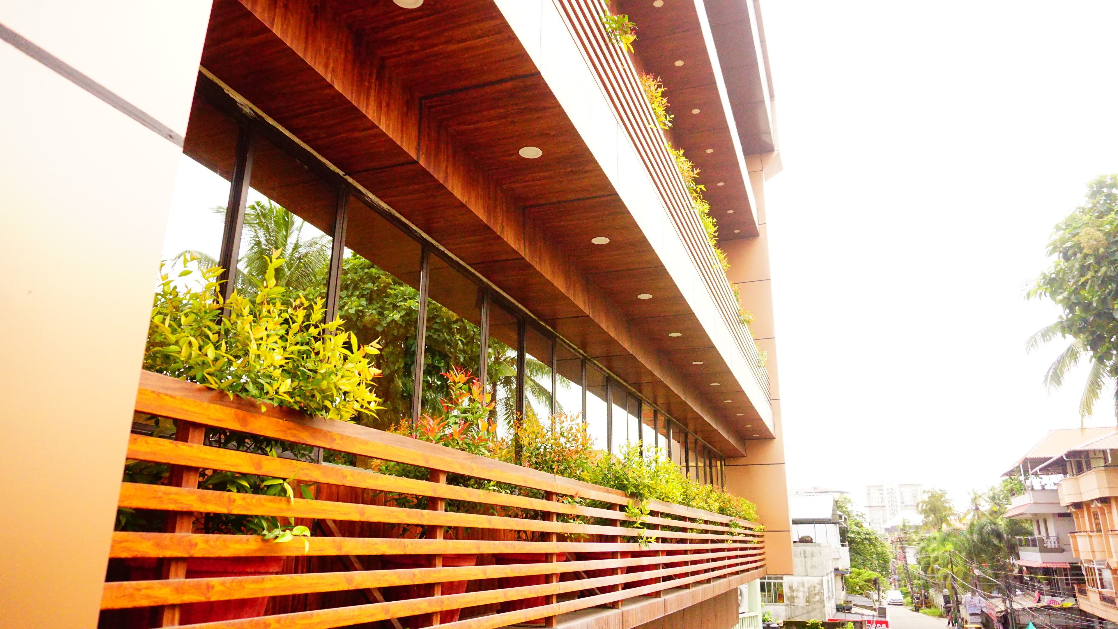A modern building with a wooden slatted facade and vertical gardens.