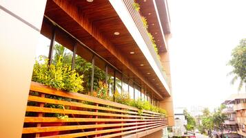 A modern building with a wooden slatted facade and vertical gardens.