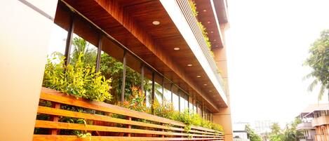 A modern building with a wooden slatted facade and vertical gardens.