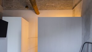 A bedroom with a bed, a white wall, and a brick ceiling. - Riposino (Marmirolo)