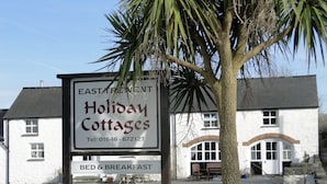 A sign for 'Holiday Cottages' with a contact number and mentions 'BED & BREAKFAST'. - East Trewent Farm B&B (Pembroke)