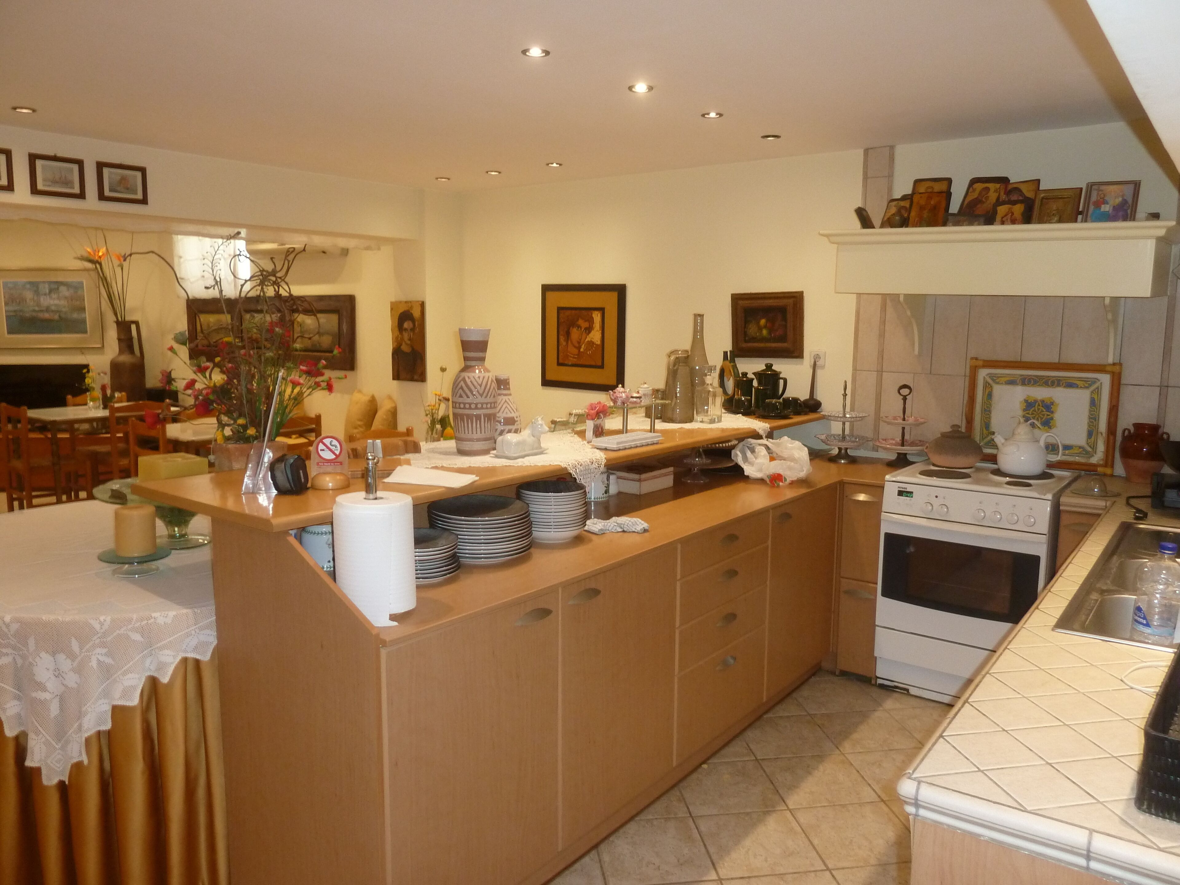 A kitchen with a wooden island, white stove, and various kitchen items.