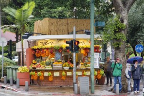 A fruit stand with various fruits displayed for sale.