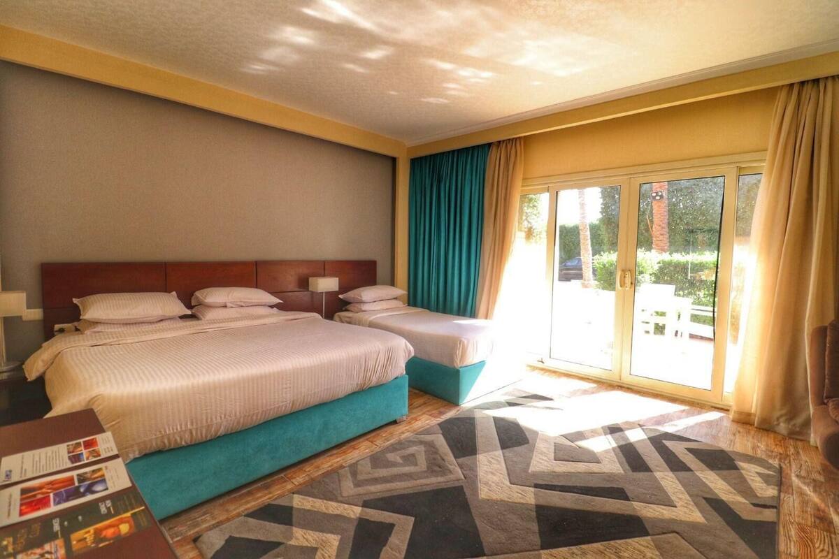 Standard Triple Room, Garden View | Minibar (free items), desk, blackout drapes, WiFi (free)