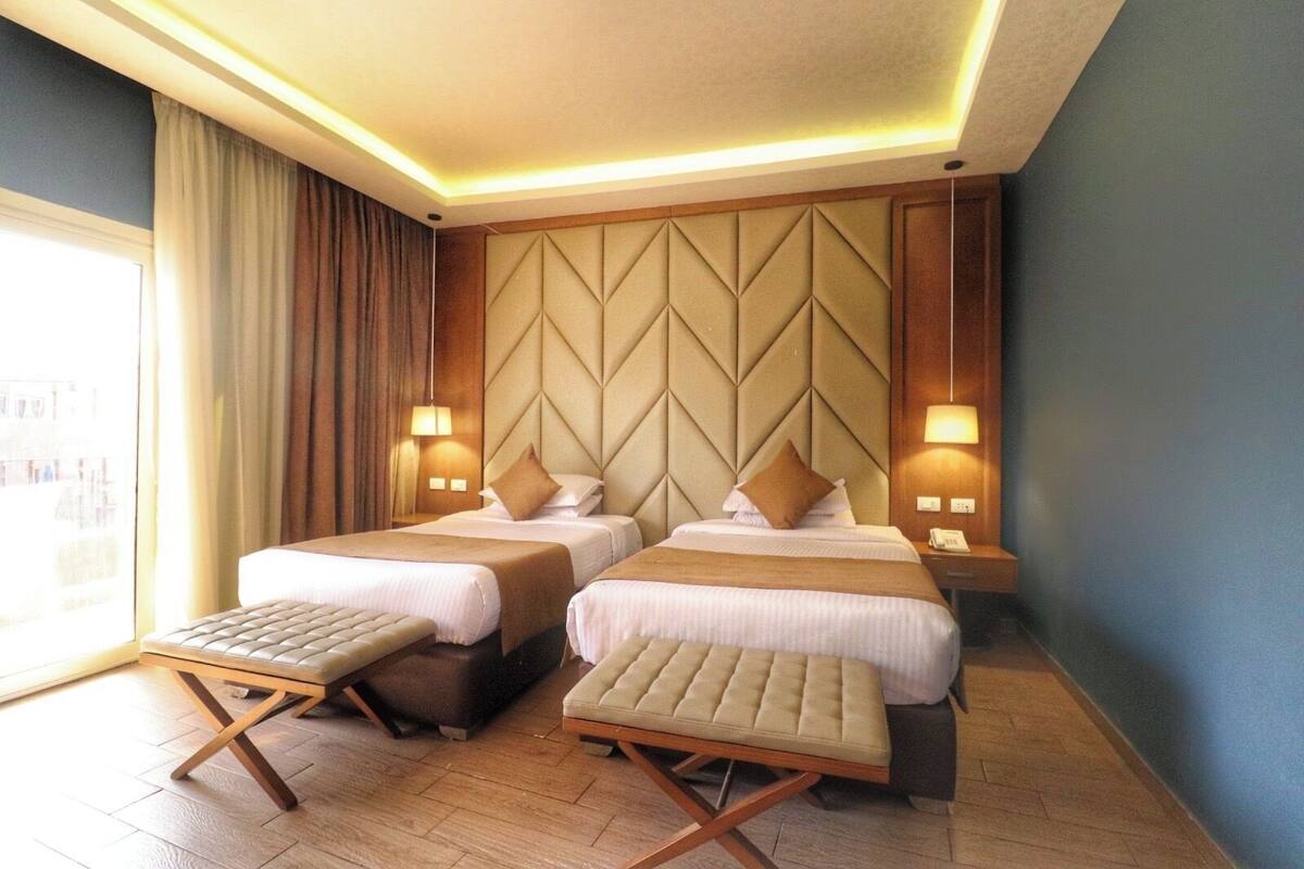 Deluxe Twin Room, Pool View | Minibar (free items), desk, blackout drapes, WiFi (free)