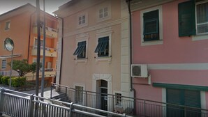 A multi-story building with balconies, a staircase, and a street view. - I Fiori di Miranda (Casarza Ligure)